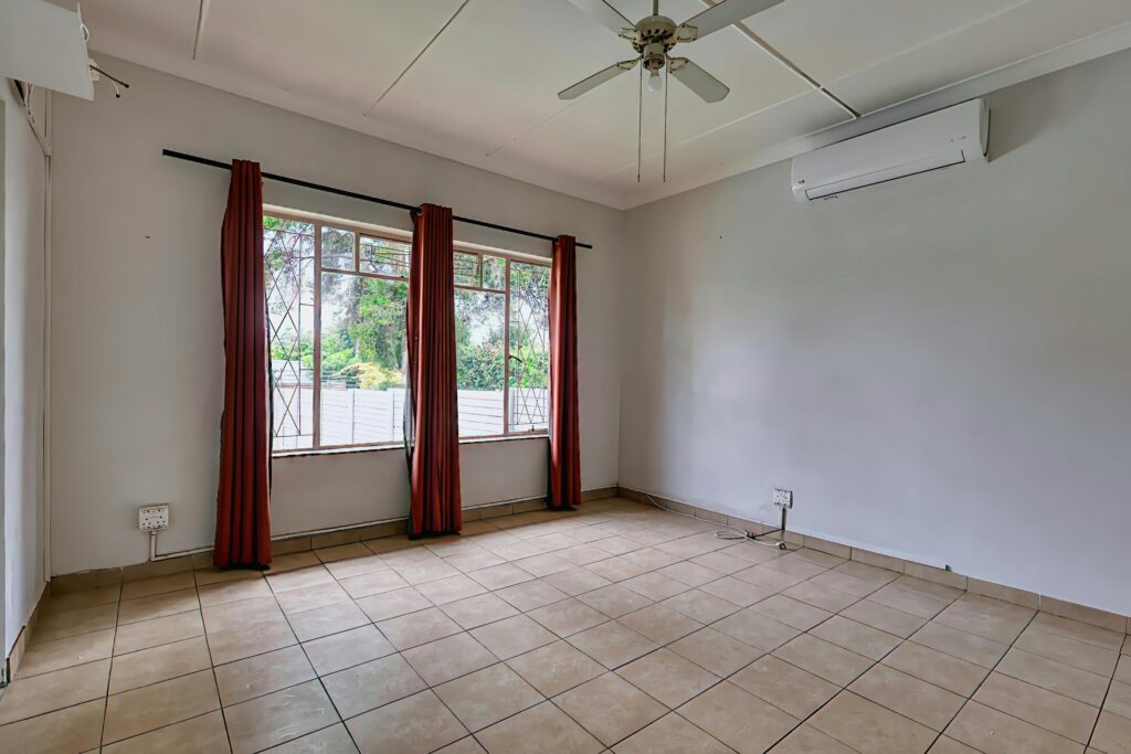 Empty room with tile floor and ceiling fan